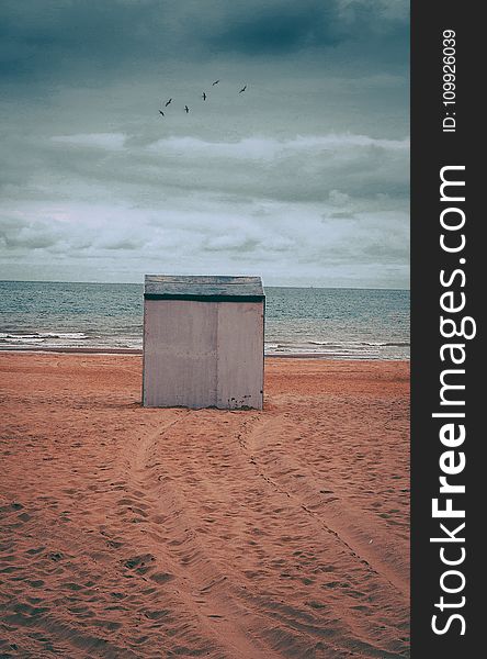 Gray Storage Shed on Brown Sand