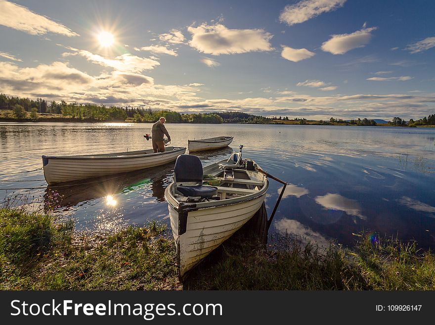 Fisherman on White Wooden Boat