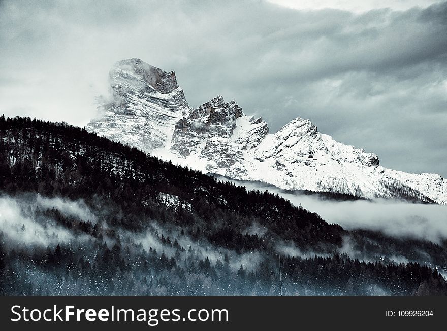 Snow Covered Mountain Under Cloudy Sky