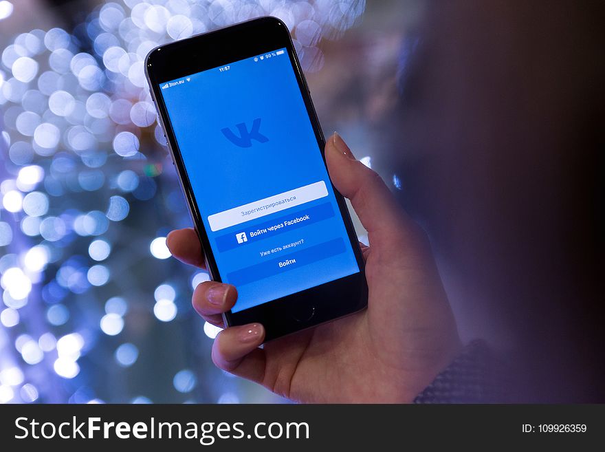 Person Holding Smartphone Displaying Vk Sign in Page
