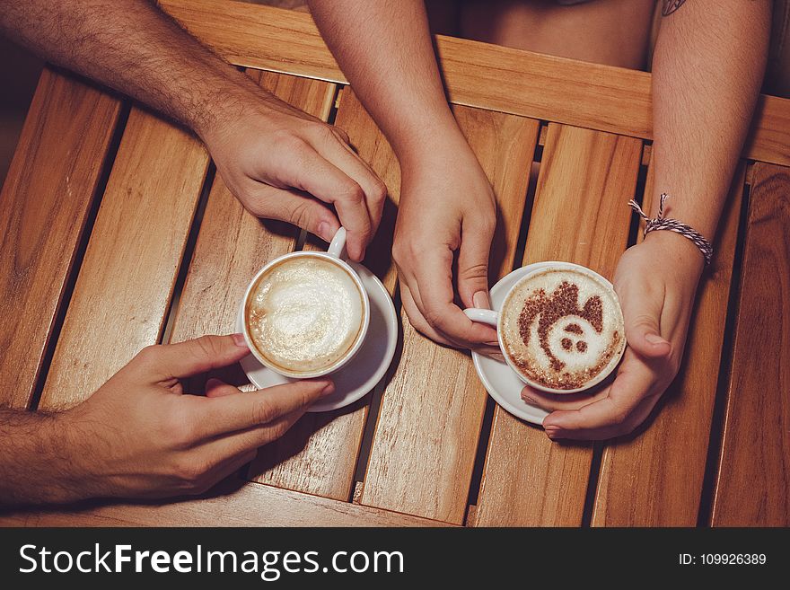 Two People Holding White Cup With Coffee