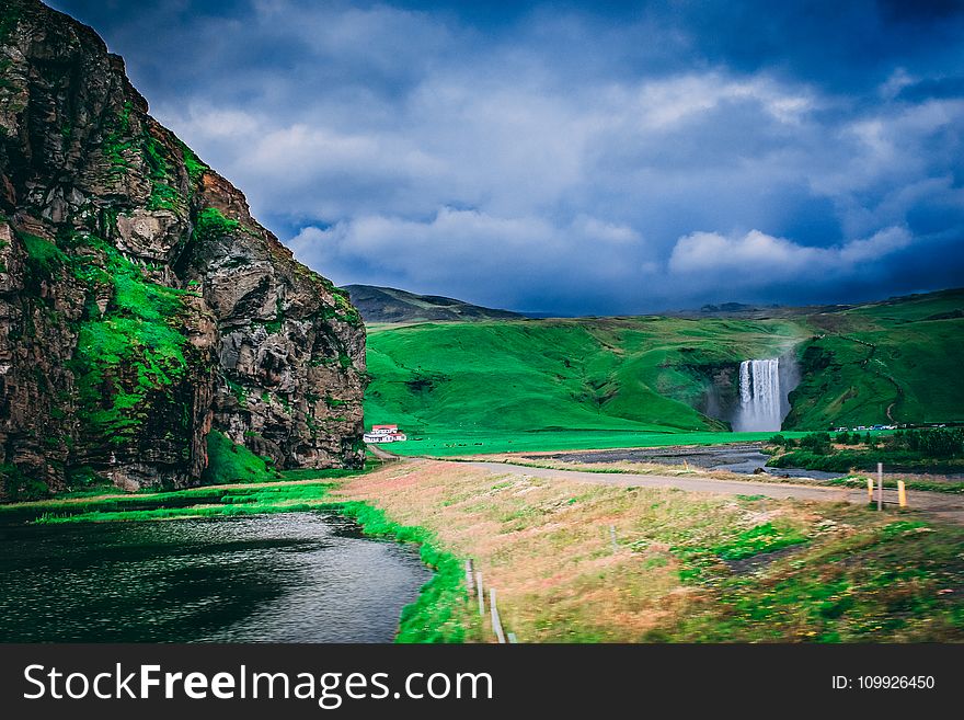 Body Of Water Near Grass Field