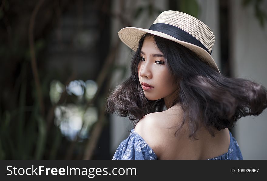 Woman Wearing Fedora Hat and Off-shoulder Top