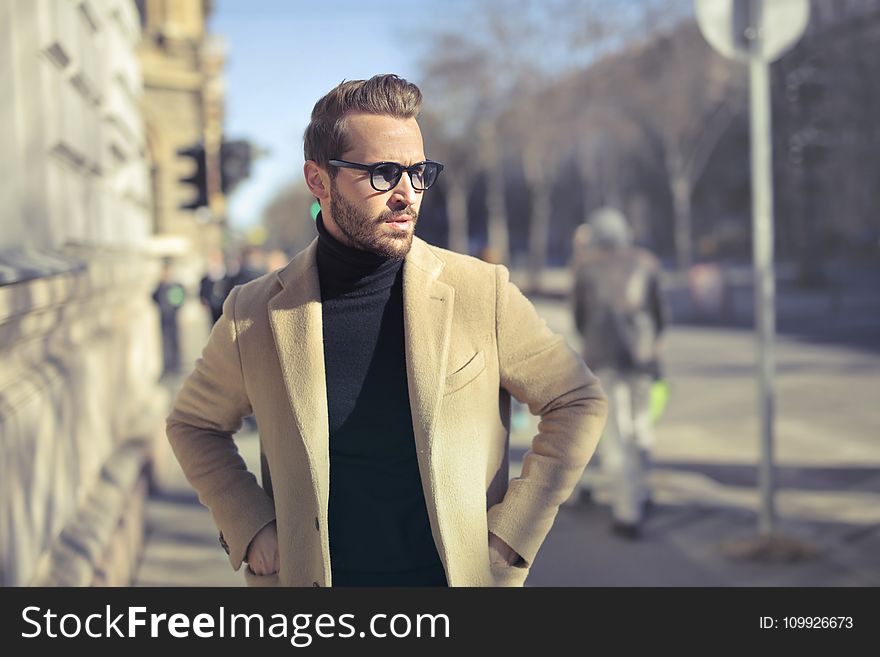 Selective Focus Photo of Man Wearing Black Turtleneck Top With Jacket on Road