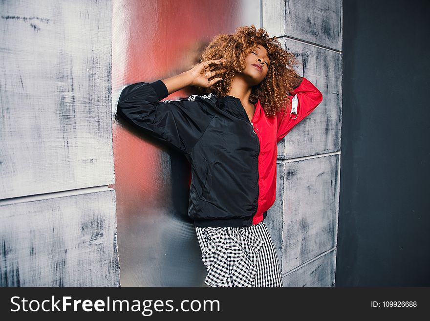 Woman in Red and Black Bomber Jacket