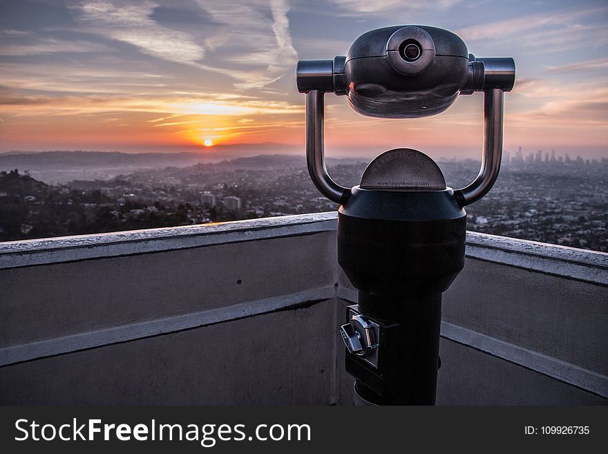 Coin-operated Tower Viewer on Rooftop during Sunset