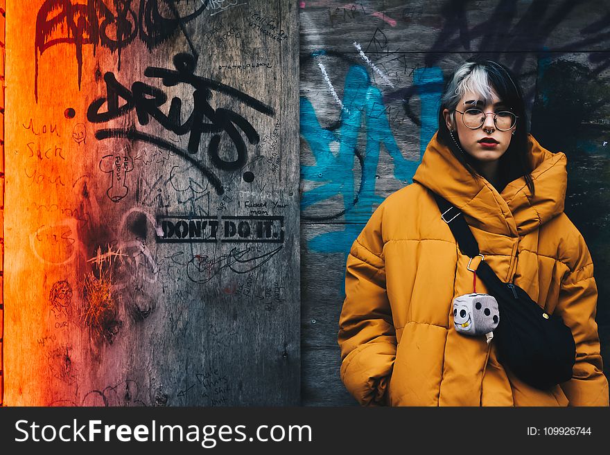 Woman in Yellow Coat With Black Crossbody Bag Closing Her Eyes