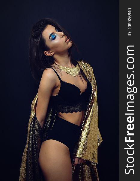 Woman Wearing Black Brassiere And Panty With Sequinned Gold-colored Coat Robe
