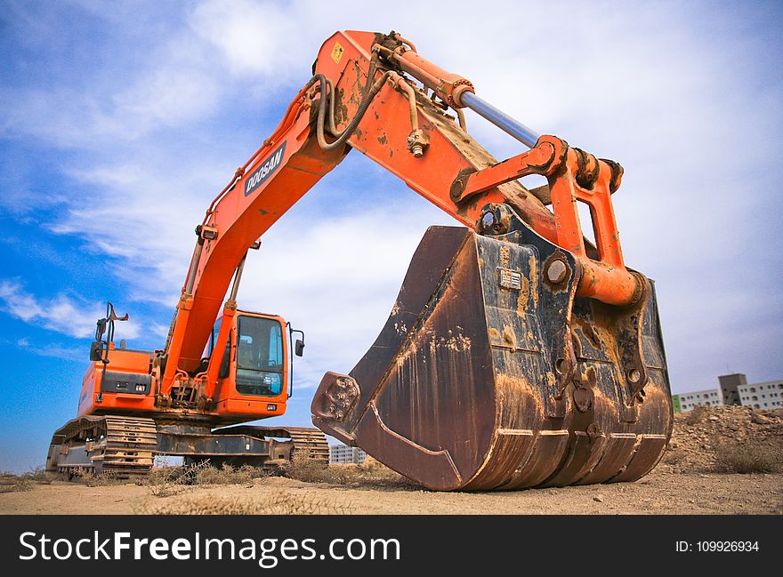 Red Excavator Under the Blue Sky