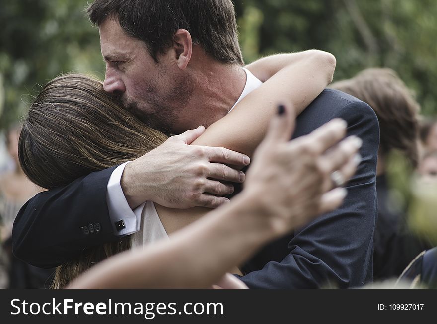 Man and Woman Hugging While Man Kissing Woman&#x27;s Head