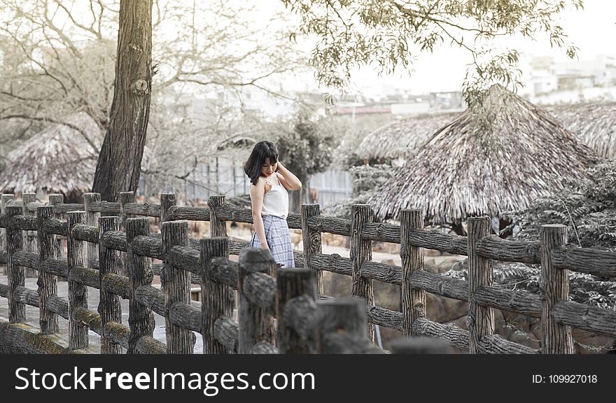 Woman Standing On Gray Bridge