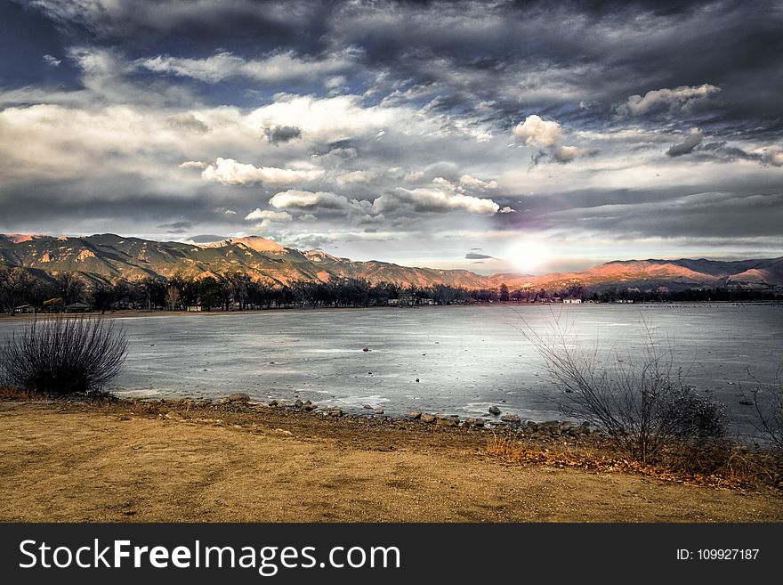 Landscape Photography of Mountains Near Body of Water