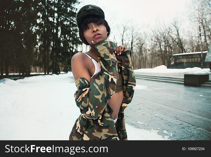 Woman Wearing Camouflage Shirt Covered By Snow