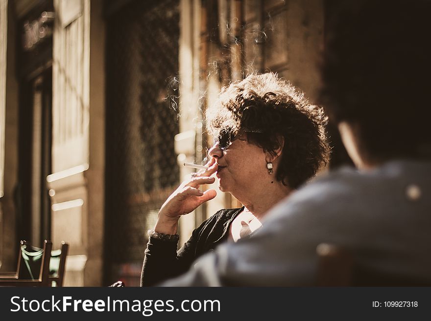 Photography Of A Woman Smoking Cigarette