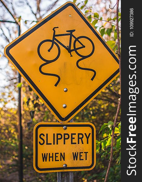Yellow and Black Slippery When Wet Road Sign Board