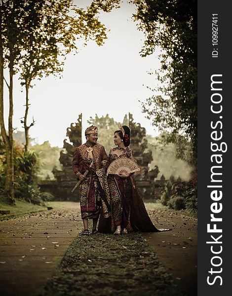 Man And Woman In Traditional Clothing Near Angkor Wat