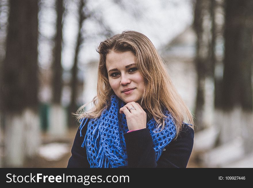 Selective Focal Photo of Woman Wearing Blue Knitted Mesh Infinity Scarf