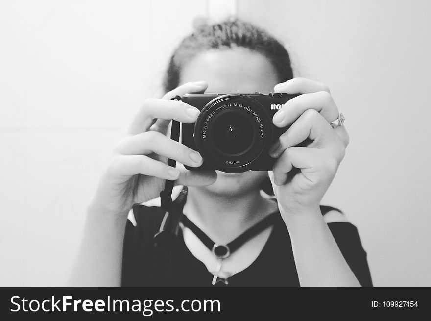 Grayscale Photo of Woman Holding Dslr Camera