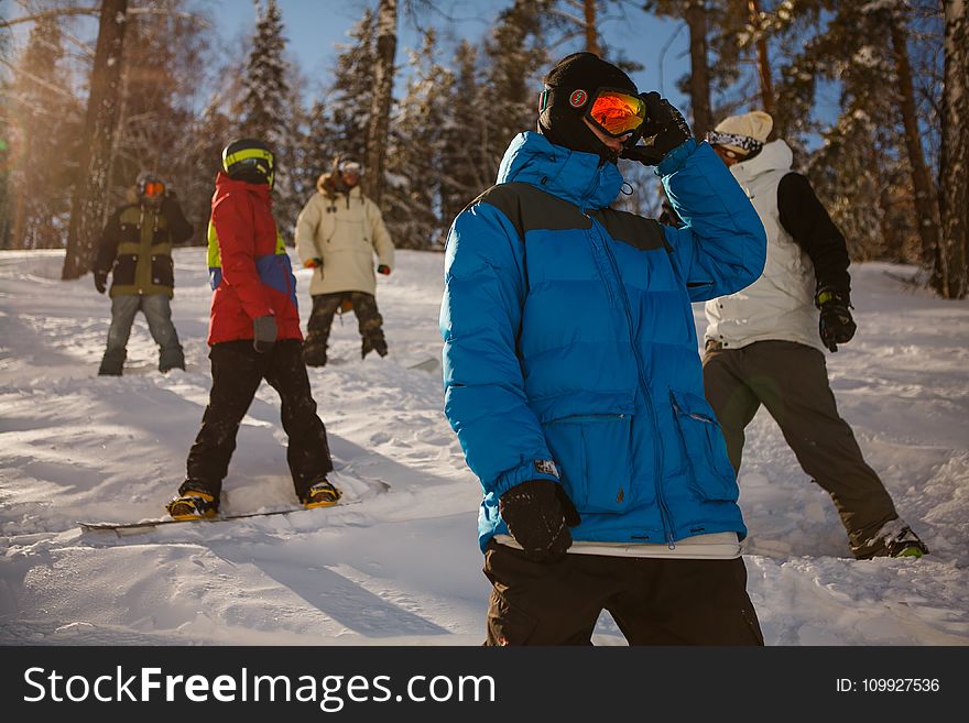 Group of People in Bubble Jackets Skiing in Mountain