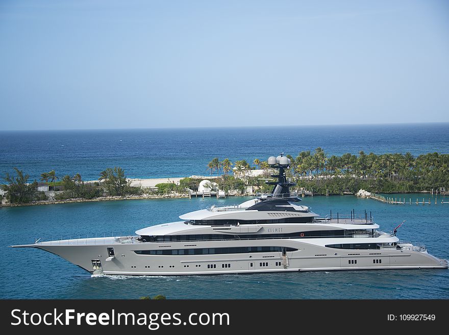 White and Blue Yacht on Body of Water