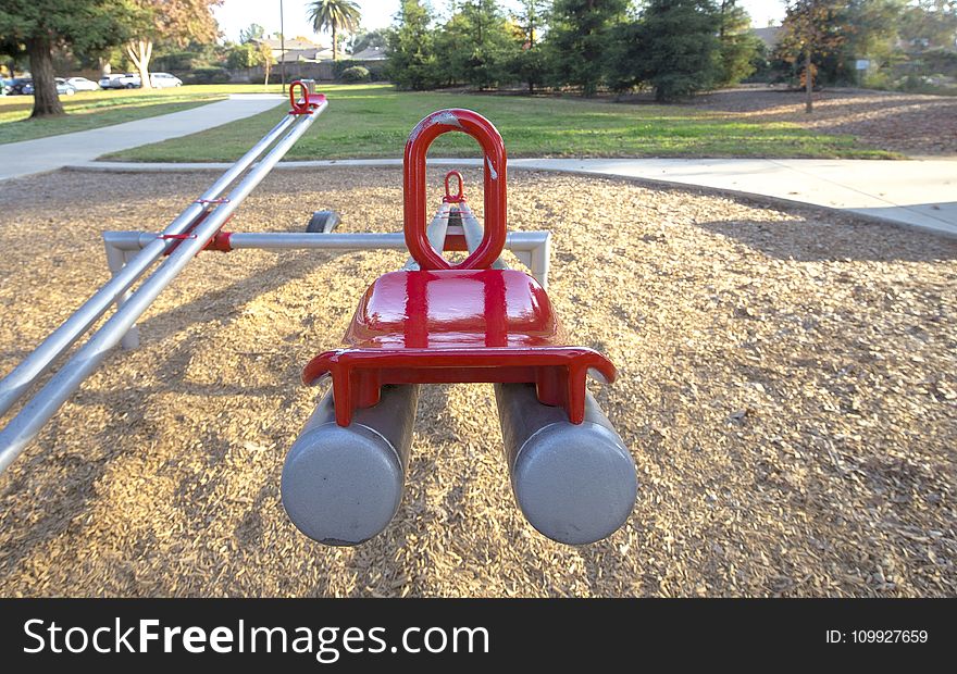 Red And Gray Seesaw In The Playground