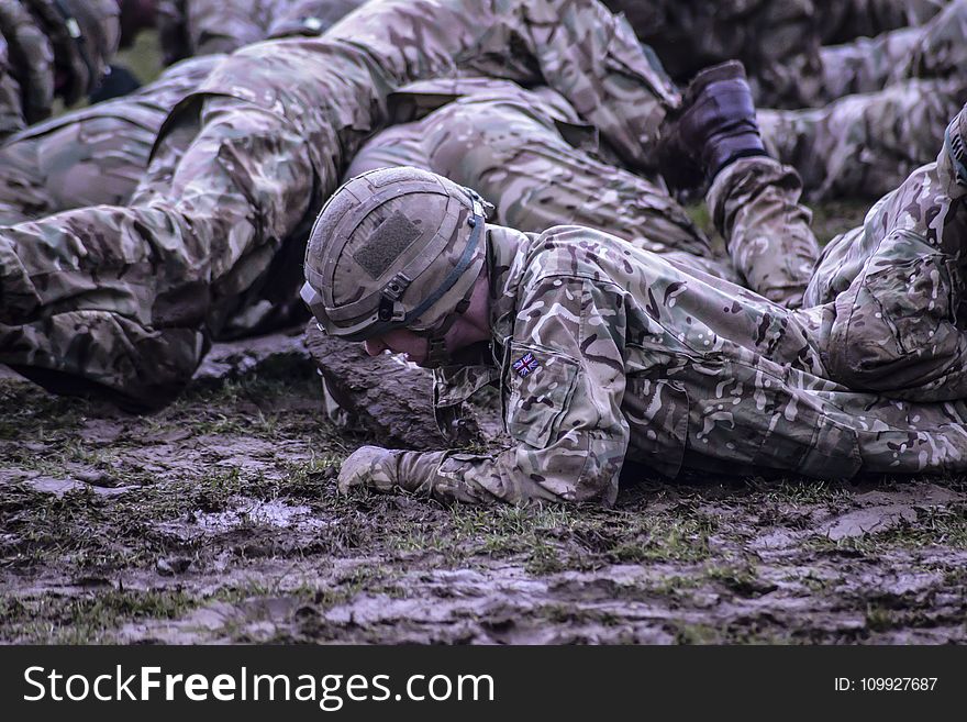 Group of Soldiers Crawling on Mud