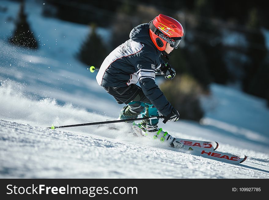 Man Doing Ice Skiing on Snow Field in Shallow Focus Photography