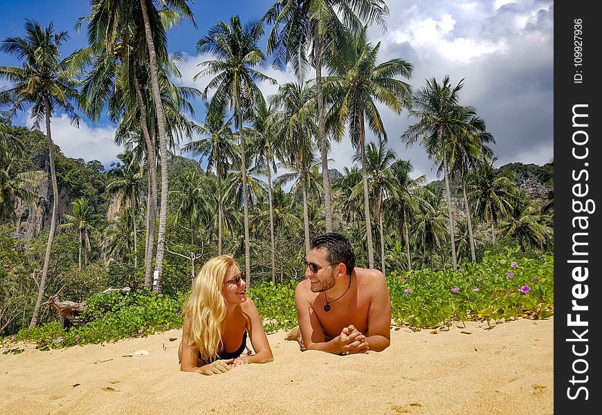 Man and Woman Lying on Sand