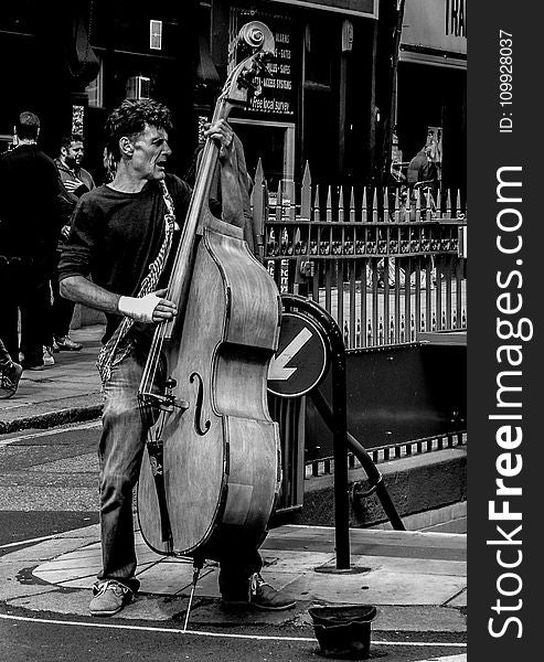 Grayscale Photography Of Man Playing Cello