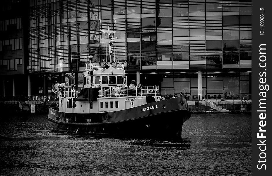 Grayscale Photo Of Ship Near Building