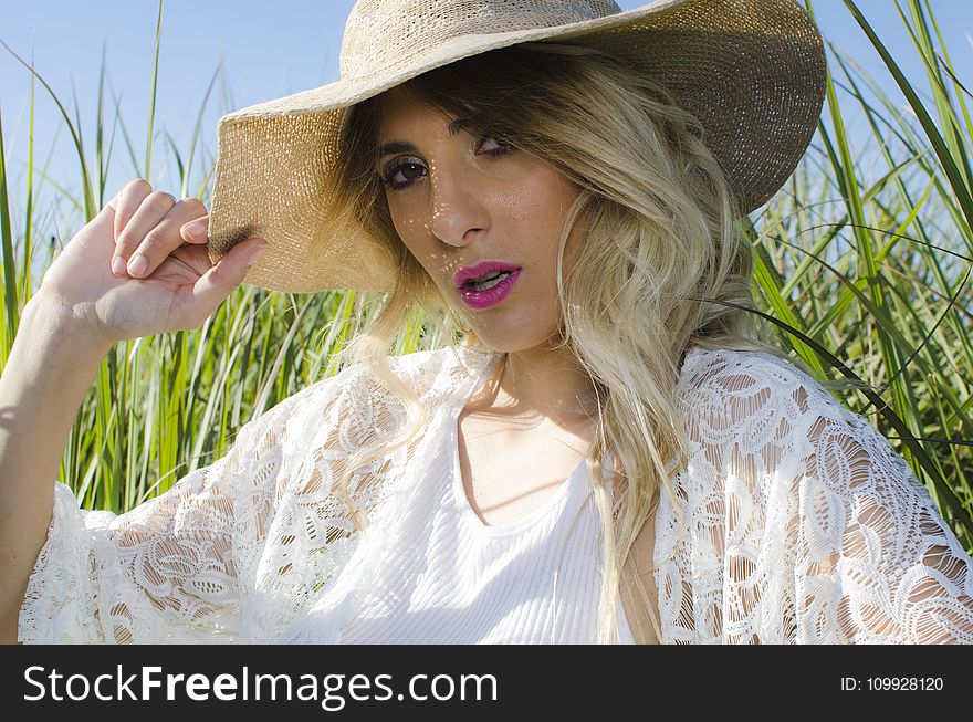 Blonde Hair Woman Wearing Brown Hat