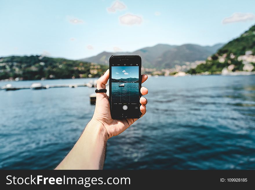 Person Holding Space Gray Iphone 5s Taking Picture of Beach