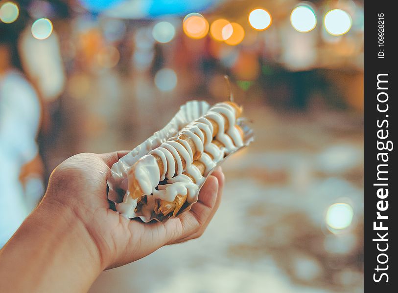 Bokeh Photo of Person Holding Shanghai Roll Wraps With Mayonnaise