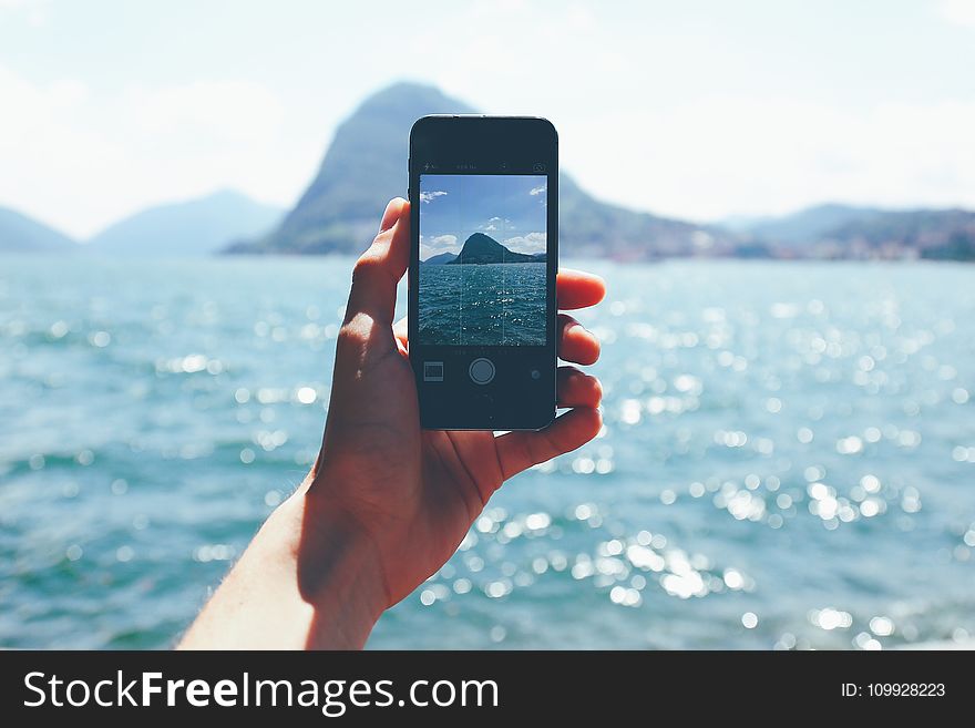 Person Taking Photo Of Mountain