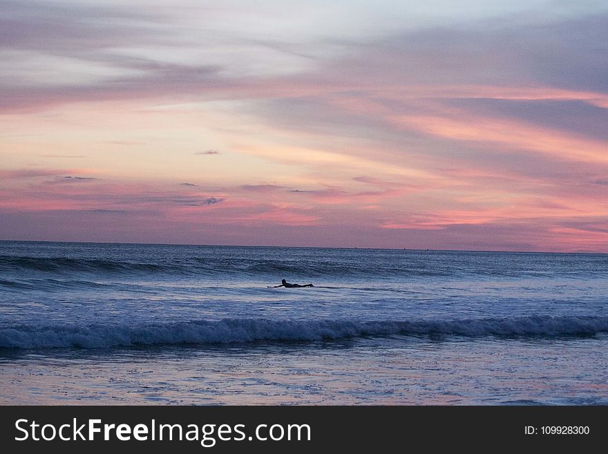 Panoramic Photography Of Surfing Man At Sunset