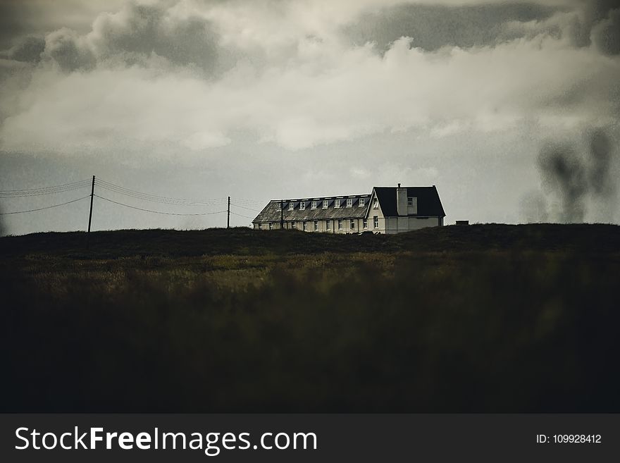 White Concrete House Under White Clouds