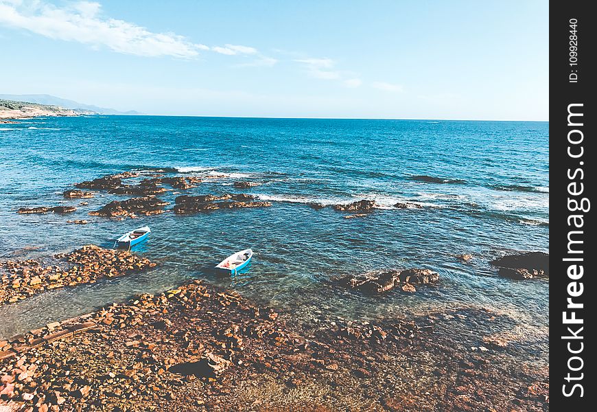 Two Blue Wooden Boats On Ocean Portrait