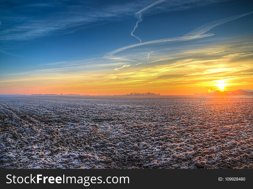 Brown Field During Sunset