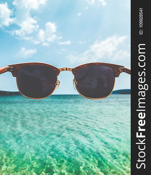 Close Up Photography of Brown Clubmaster Style Sunglasses