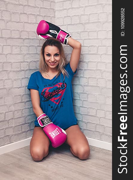 Woman Wearing Blue Crew-neck Shirt and Pink Boxing Gloves