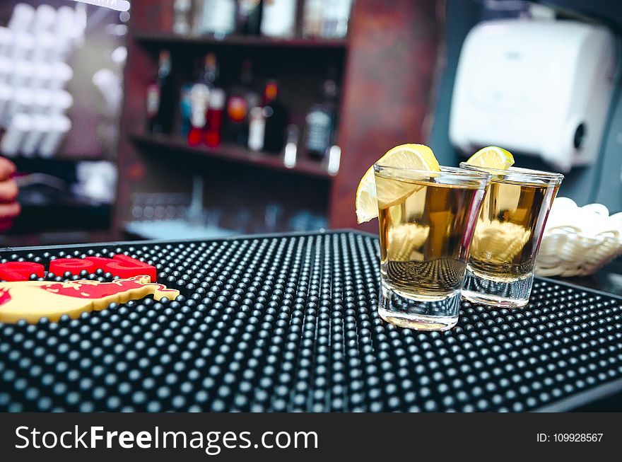 Two Clear Shot Glasses Filled With Alcohol