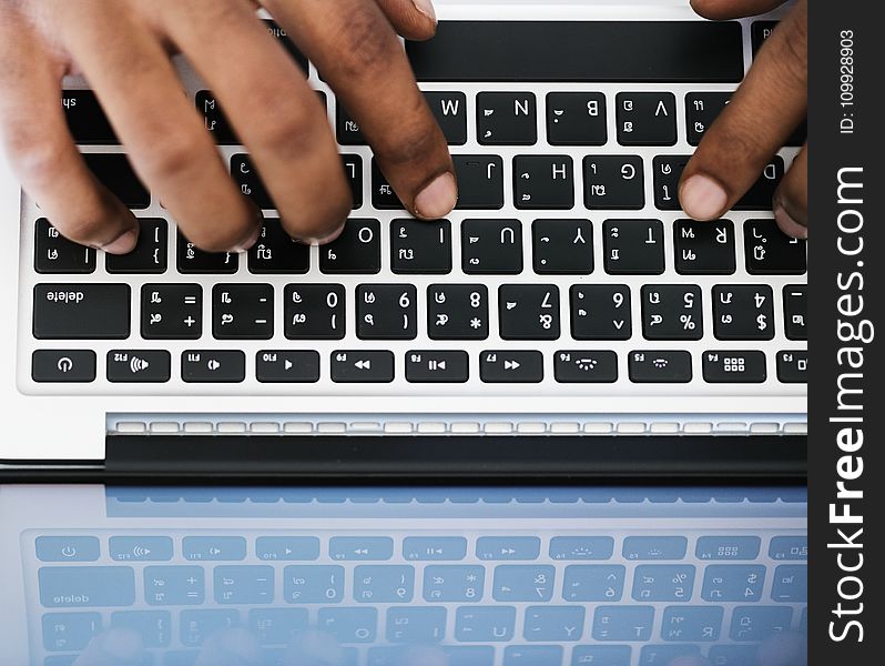 Person Typing on White and Black Laptop Computer