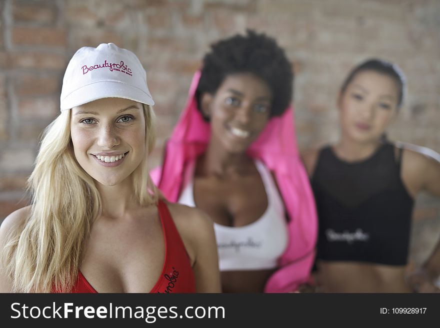 Three Woman Wearing of Red, White, and Black Sport Bras