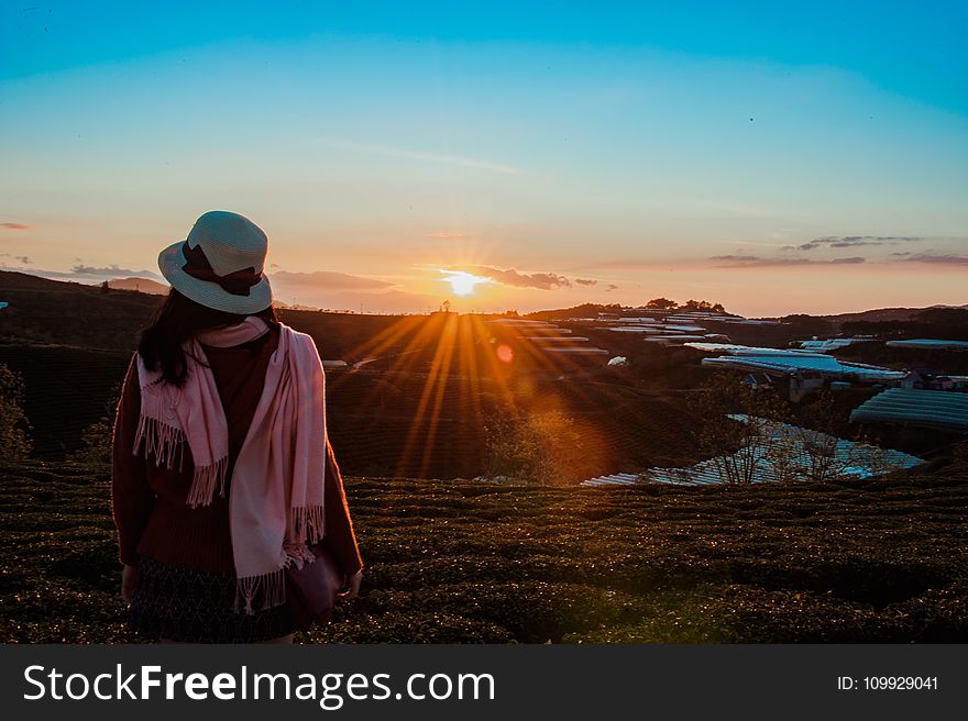 Person Wearing White Fedora Hat and Pink Scarf during Golden Hour