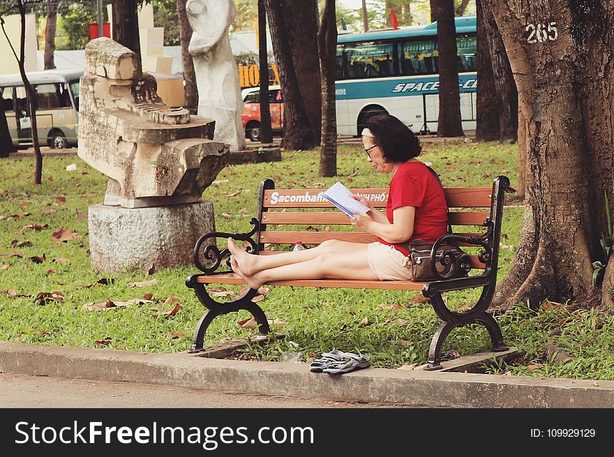 Woman In Red Shirt Sitting On Bench