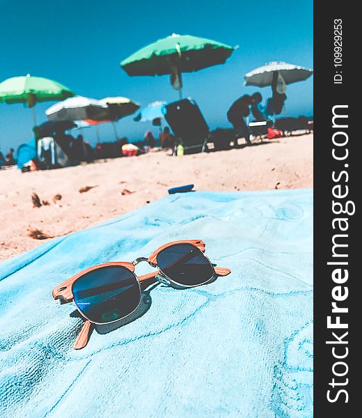 Brown Clubmaster Sunglasses On Blue Towel