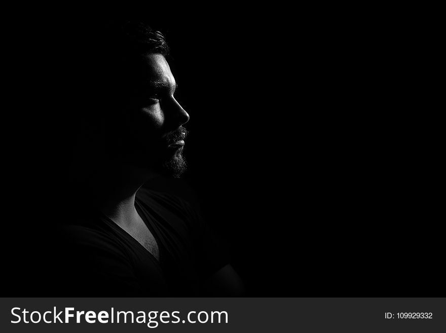Grayscale Photo of Man in Black V Neck Shirt With Black Background