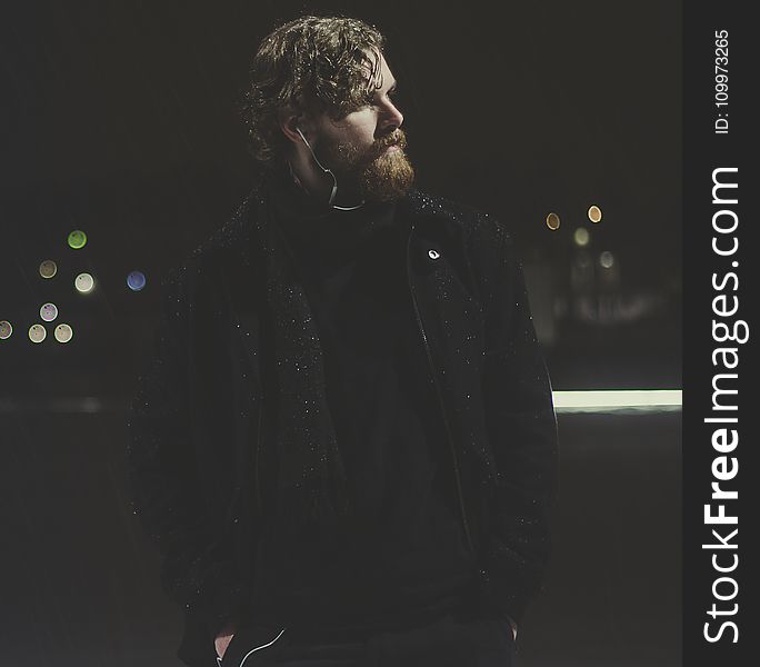 Man Wearing Black Zip-up Jacket Taking Picture during Nighttime