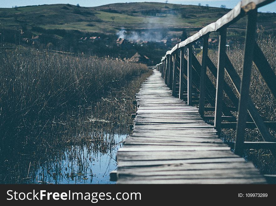 Landscape Photograph of Wooden Bridge Going Up the Mountain