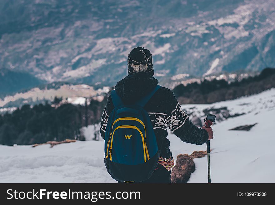 Man in Black and White Jacket and Blue Backpack Doing Snow Ski